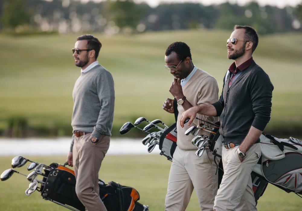 multiethnic-golfers-holding-bags-with-golf-clubs-a-2022-11-02-03-17-12-utc.jpg