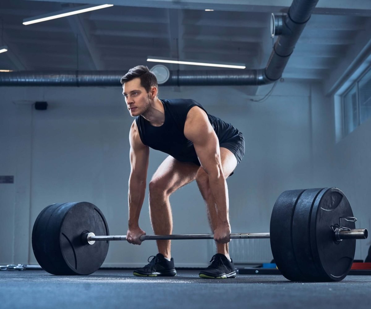 man-doing-barbell-exercise-at-gym-during-weight-li-2022-03-08-01-03-53-utc-scaled.jpg