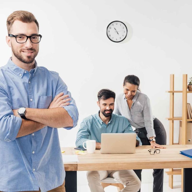 businessman-with-crossed-arms-standing-in-office-a-KYQGLWN-1.jpg