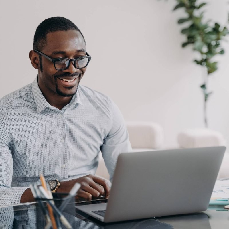 smiling-african-american-man-wearing-glasses-worki-2022-11-29-02-22-45-utc.jpg